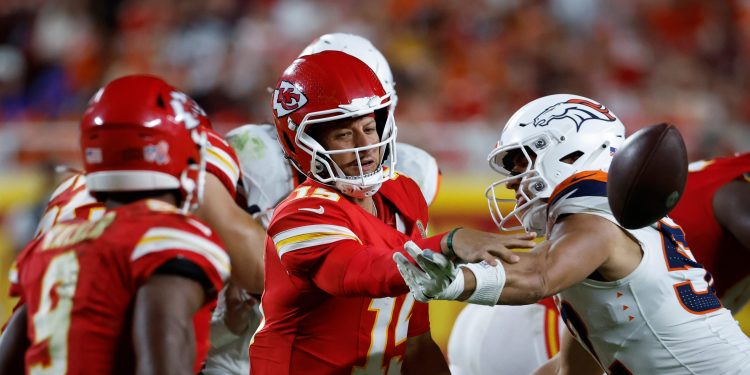 Kansas City Chiefs quarterback Patrick Mahomes (15) shuffle passes to running back Kenneth Walker III (9) during an NFL football game against the Denver Broncos, Monday, Sept. 14, 2026, in Kansas City, Mo. (AP Photo/Colin E. Braley)