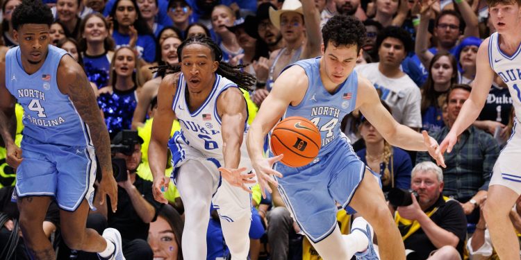 Duke's Maliq Brown (6) and North Carolina's Luka Bogavac (44) chase a loose ball during the first half of an NCAA college basketball game in Durham, N.C., Saturday, March 7, 2026. (AP Photo/Ben McKeown)