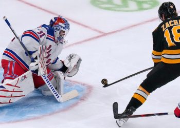 New York Rangers' Igor Shesterkin (31) drops to make a save on a shot by Boston Bruins' Pavel Zacha (18) during the second period of an NHL hockey game, Tuesday, Sept. 29, 2026, in Boston. (AP Photo/Charles Krupa)