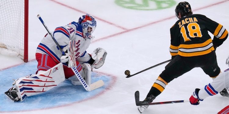 New York Rangers' Igor Shesterkin (31) drops to make a save on a shot by Boston Bruins' Pavel Zacha (18) during the second period of an NHL hockey game, Tuesday, Sept. 29, 2026, in Boston. (AP Photo/Charles Krupa)