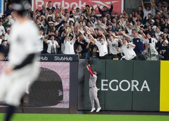 Fans fight for a ball hit by New York Yankees' Cody Bellinger for a three-run home run during the sixth inning in Game 2 of baseball's American League Wild Card Series against the Boston Red Sox Wednesday, Sept. 30, 2026, in New York. (AP Photo/Frank Franklin II)