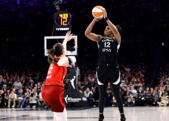 Las Vegas Aces guard Chelsea Gray (12) shoots over Indiana Fever guard Caitlin Clark during the second half in Game 3 of an WNBA basketball first-round playoff series Thursday, Oct.1, 2026, in Las Vegas. (AP Photo/Steve Marcus)