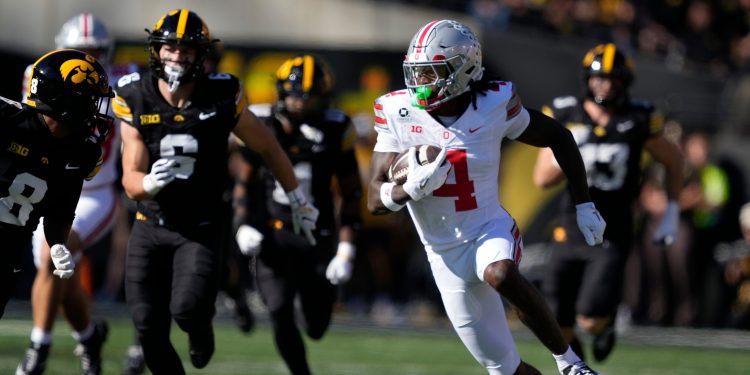 Ohio State wide receiver Jeremiah Smith (4) runs up field after catching a pass during the first half of an NCAA college football game against Iowa, Saturday, Oct. 3, 2026, in Iowa City, Iowa. (AP Photo/Charlie Neibergall)