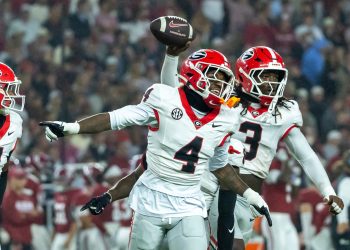 Georgia defensive back KJ Bolden (4) and linebacker Quintavius Johnson (3) celebrate after Johnson's fumble recovery during the first half of an NCAA college football game against Alabama, Saturday, Oct. 10, 2026, in Tuscaloosa, Ala. (AP Photo/Vasha Hunt)