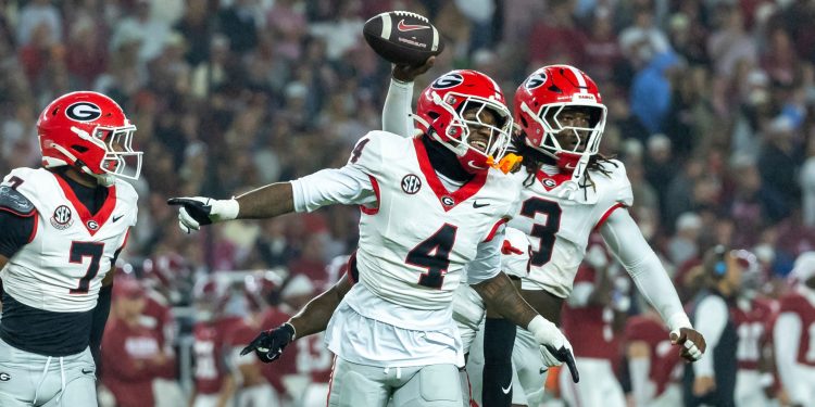 Georgia defensive back KJ Bolden (4) and linebacker Quintavius Johnson (3) celebrate after Johnson's fumble recovery during the first half of an NCAA college football game against Alabama, Saturday, Oct. 10, 2026, in Tuscaloosa, Ala. (AP Photo/Vasha Hunt)