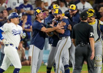 Los Angeles Dodgers third baseman Kiké Hernández, left, leaves the field after making the final out as the Milwaukee Brewers celebrate with pitcher Aaron Ashby, center, after Game 4 of baseball's National League Championship Series between the Milwaukee Brewers and the Los Angeles Dodgers, Thursday, Oct. 15, 2026, in Los Angeles. (AP Photo/Mark J. Terrill)