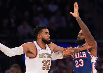 New York Knicks center Karl-Anthony Towns (32) looks to pass as Philadelphia 76ers forward LeBron James (23) defends during the second half of an NBA basketball game Tuesday, Oct. 20, 2026, in New York. (AP Photo/Frank Franklin II)