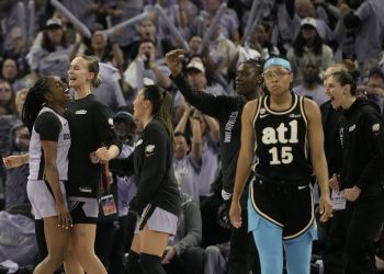 Atlanta Dream guard Allisha Gray, foreground right, walks toward the bench as Golden State Valkyries guard Tiffany Hayes, left, is congratulated by teammates after scoring during the second half of Game 5 of the WNBA basketball finals, Monday, Oct. 26, 2026, in San Francisco. (AP Photo/Jeff Chiu)