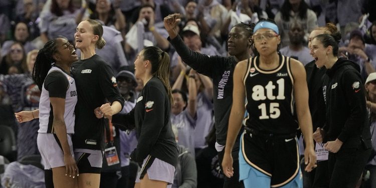 Atlanta Dream guard Allisha Gray, foreground right, walks toward the bench as Golden State Valkyries guard Tiffany Hayes, left, is congratulated by teammates after scoring during the second half of Game 5 of the WNBA basketball finals, Monday, Oct. 26, 2026, in San Francisco. (AP Photo/Jeff Chiu)